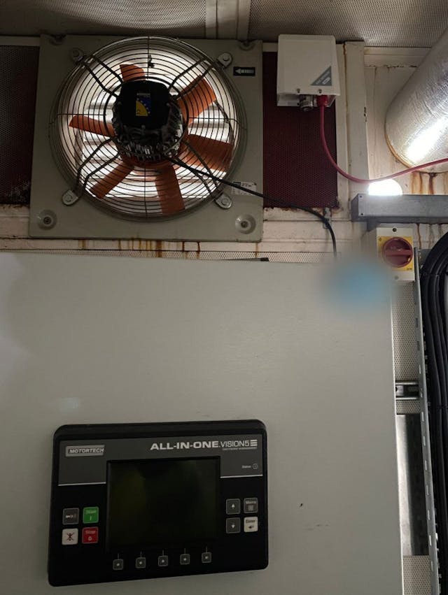 4-Genset-ContainerImage of interior of purpose made generator container with part of control panel and ventilation fan